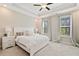 Bright bedroom with a tray ceiling, ceiling fan, and large windows with natural light at 938 Catamaran Ct, Alpharetta, GA 30005