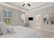 Bedroom featuring a TV, en-suite bathroom, neutral decor, and comfortable carpeting at 938 Catamaran Ct, Alpharetta, GA 30005