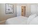 A clean bedroom with a modern painting and en-suite bathroom at 938 Catamaran Ct, Alpharetta, GA 30005