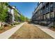 A serene community street with well-maintained lawns, sidewalks, and inviting townhouse facades on either side at 938 Catamaran Ct, Alpharetta, GA 30005