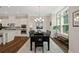 Stylish dining room with modern chandelier, large windows, open to the kitchen featuring stainless appliances at 938 Catamaran Ct, Alpharetta, GA 30005
