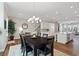 Elegant dining area with hardwood floors, open to kitchen and living spaces, filled with natural light at 938 Catamaran Ct, Alpharetta, GA 30005