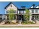 Beautiful townhomes with brick and siding exteriors, showcasing manicured lawns and inviting front entrances at 938 Catamaran Ct, Alpharetta, GA 30005