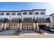 Modern townhome row with individual garages and balconies for each unit at 938 Catamaran Ct, Alpharetta, GA 30005