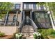 Charming front entrance featuring a light brick facade, dark trim, and inviting staircase with flower boxes at 938 Catamaran Ct, Alpharetta, GA 30005