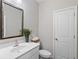 Well-lit half bathroom with modern vanity, mirror, and convenient toilet at 938 Catamaran Ct, Alpharetta, GA 30005