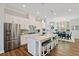 Bright kitchen with white cabinets, stainless steel appliances, and a large island with seating at 938 Catamaran Ct, Alpharetta, GA 30005