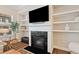 Living room with a modern fireplace, built-in shelving, and recessed lighting at 938 Catamaran Ct, Alpharetta, GA 30005