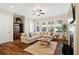 Spacious living room featuring a fireplace, large windows, and hardwood floors at 938 Catamaran Ct, Alpharetta, GA 30005