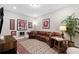Comfortable living room showcasing a leather sofa, rug, and sports-themed decor at 938 Catamaran Ct, Alpharetta, GA 30005