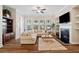 Inviting living room with a fireplace, built-in shelves, and a comfortable sectional sofa at 938 Catamaran Ct, Alpharetta, GA 30005