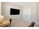 Office featuring a desk, chair, large TV, and ample natural light at 938 Catamaran Ct, Alpharetta, GA 30005