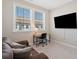 Office space with a mounted TV, desk, chair, and comfortable seating at 938 Catamaran Ct, Alpharetta, GA 30005
