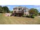 Expansive backyard featuring a brick home, spacious deck, and lush green lawn at 1950 Lancaster Se Dr, Conyers, GA 30013