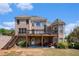 A backyard features a two-story brick house with a deck and covered patio at 1950 Lancaster Se Dr, Conyers, GA 30013