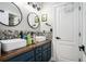 Stylish bathroom features double sinks, a wood countertop, and modern fixtures at 1950 Lancaster Se Dr, Conyers, GA 30013