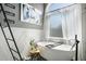 Charming bathroom featuring a soaking tub, natural light and relaxing atmosphere at 1950 Lancaster Se Dr, Conyers, GA 30013