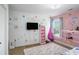 Playful bedroom with colorful decor, hanging chair, and whimsical accents at 1950 Lancaster Se Dr, Conyers, GA 30013