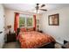 Cozy bedroom with large window, ceiling fan, and decorative accents at 1950 Lancaster Se Dr, Conyers, GA 30013