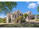 Brick home with manicured lawn, mature trees and blue skies in the background at 1950 Lancaster Se Dr, Conyers, GA 30013