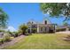 Beautiful brick home with manicured lawn and mature trees, with blue skies in the background at 1950 Lancaster Se Dr, Conyers, GA 30013