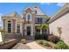 Brick home entrance with mature landscaping, walkway and a black front door at 1950 Lancaster Se Dr, Conyers, GA 30013