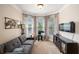 Cozy living area features a bay window, plush seating, and sleek media console at 1950 Lancaster Se Dr, Conyers, GA 30013