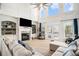 Spacious living room with fireplace, built-in shelving and large windows at 1950 Lancaster Se Dr, Conyers, GA 30013