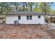 Backyard features a freshly painted white brick exterior, with neatly arranged windows and well-maintained landscape at 2804 Dearwood Sw Dr, Atlanta, GA 30315