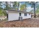 Newly renovated white brick house featuring sleek windows and a modern air conditioning system for optimal climate control at 2804 Dearwood Sw Dr, Atlanta, GA 30315