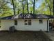 Back view of house with recently painted white bricks and dark roofing and a well-sized air conditioning unit at 2804 Dearwood Sw Dr, Atlanta, GA 30315
