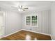 Cozy bedroom featuring natural light, original hardwood floors, and access to bathroom at 2804 Dearwood Sw Dr, Atlanta, GA 30315