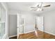 Bedroom showcasing gleaming hardwood floors, ceiling fan, and attached bathroom at 2804 Dearwood Sw Dr, Atlanta, GA 30315