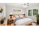 Bright bedroom features wood floors, fresh paint, ceiling fan, and windows with pleasant views at 2804 Dearwood Sw Dr, Atlanta, GA 30315
