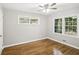 Bedroom with hardwood floors, a ceiling fan, and two large windows at 2804 Dearwood Sw Dr, Atlanta, GA 30315