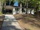 Charming single-story white home with a black trim, car port, and a front porch with black railings at 2804 Dearwood Sw Dr, Atlanta, GA 30315