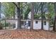 Charming single-story white home with a black trim, car port, and a front porch with black railings at 2804 Dearwood Sw Dr, Atlanta, GA 30315