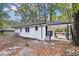 Charming home showcasing fresh paint, a covered parking area, and mature trees at 2804 Dearwood Sw Dr, Atlanta, GA 30315
