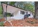 Charming single-story white home with a black trim, car port, and a front porch with black railings at 2804 Dearwood Sw Dr, Atlanta, GA 30315