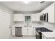 Clean kitchen with white cabinets, stainless steel appliances, and marbled floors at 2804 Dearwood Sw Dr, Atlanta, GA 30315