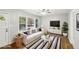 Sunlit living room features wood floors, ceiling fan, and view of front yard at 2804 Dearwood Sw Dr, Atlanta, GA 30315