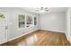 Living room with hardwood floors, a ceiling fan, and a large window at 2804 Dearwood Sw Dr, Atlanta, GA 30315
