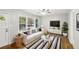 Sunlit living room features wood floors, ceiling fan, and view of front yard at 2804 Dearwood Sw Dr, Atlanta, GA 30315