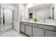 Bathroom boasts a double vanity, framed mirror, and glass-enclosed shower at 309 Vista Ln, Woodstock, GA 30189