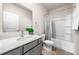 Neat bathroom featuring gray cabinets, a sink, toilet and shower tub combination with curtain at 309 Vista Ln, Woodstock, GA 30189