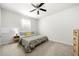 Comfortable bedroom with a ceiling fan, a queen-size bed, and a nightstand with lamp at 309 Vista Ln, Woodstock, GA 30189