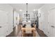 Open-concept kitchen and dining area featuring hardwood floors and modern chandelier at 309 Vista Ln, Woodstock, GA 30189