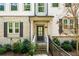 Inviting front entry with brick accents, a covered porch, and a well landscaped garden at 309 Vista Ln, Woodstock, GA 30189