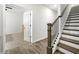 Bright hallway with hardwood floors, a staircase, and an open doorway to a bedroom at 309 Vista Ln, Woodstock, GA 30189