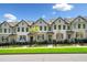 Desirable street view of pristine townhomes with neutral siding and manicured front yards at 309 Vista Ln, Woodstock, GA 30189